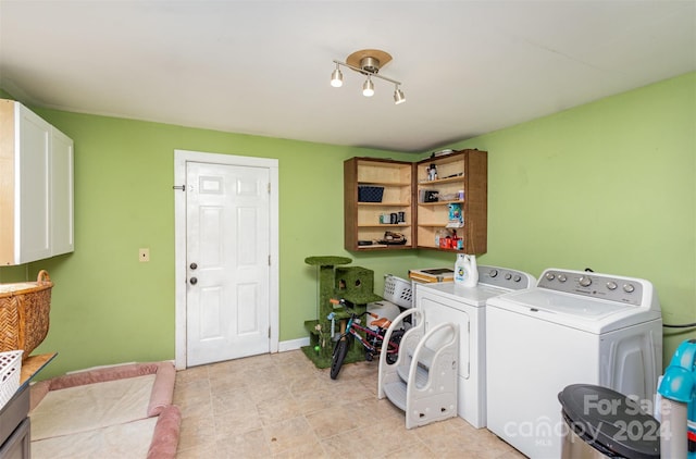 laundry room featuring separate washer and dryer and cabinets