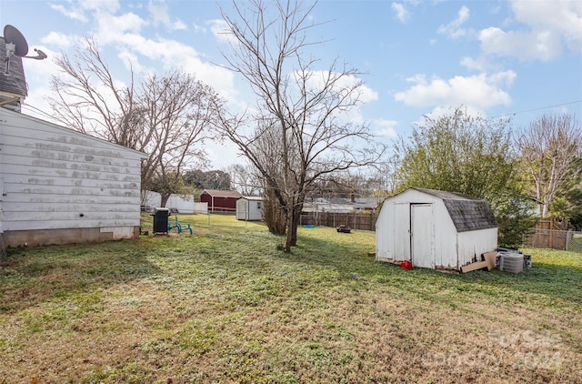 view of yard featuring a storage unit and central AC