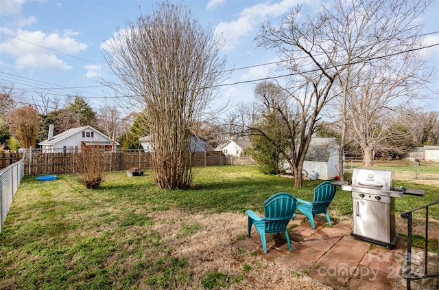 view of yard featuring a storage unit and a patio area