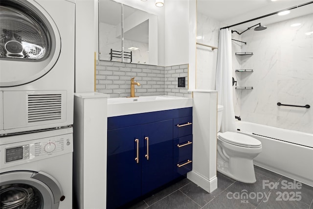 full bathroom with vanity, tile patterned floors, toilet, shower / bath combo with shower curtain, and stacked washer / dryer