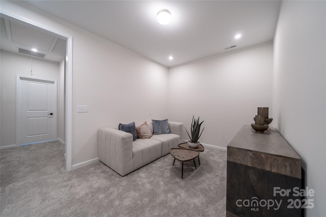 living area featuring attic access, carpet flooring, baseboards, and visible vents