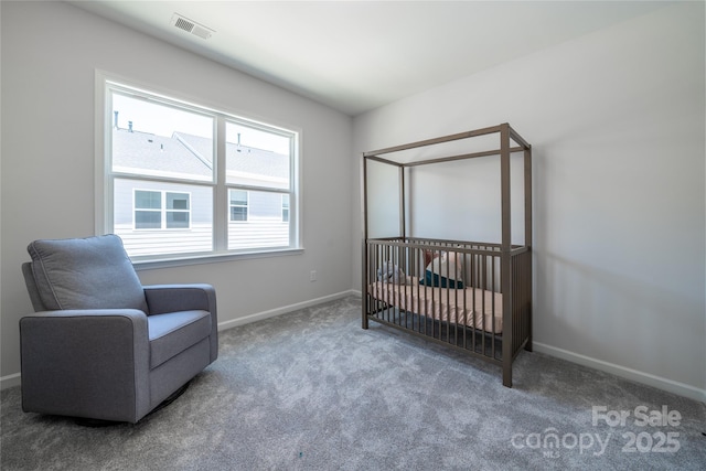 bedroom featuring visible vents, carpet floors, baseboards, and a crib