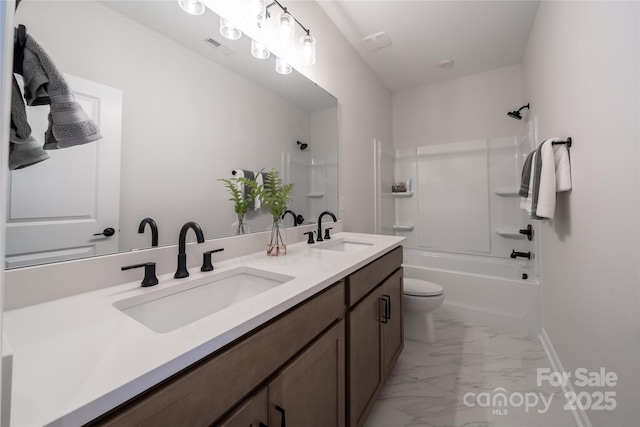 bathroom featuring double vanity, marble finish floor, bathing tub / shower combination, and a sink