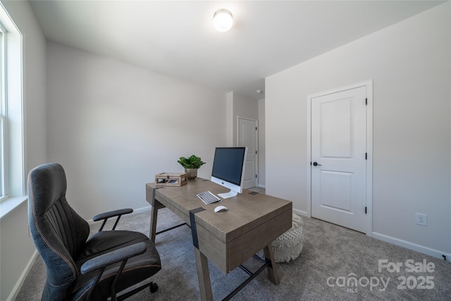 carpeted office space with baseboards