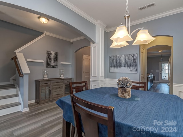 dining area featuring crown molding and dark wood-type flooring