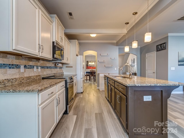 kitchen with stainless steel appliances, white cabinetry, and sink