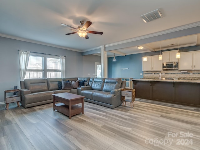 living room featuring ceiling fan, light wood-type flooring, and ornamental molding