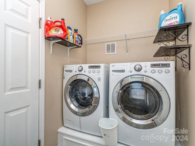 clothes washing area featuring washer and clothes dryer