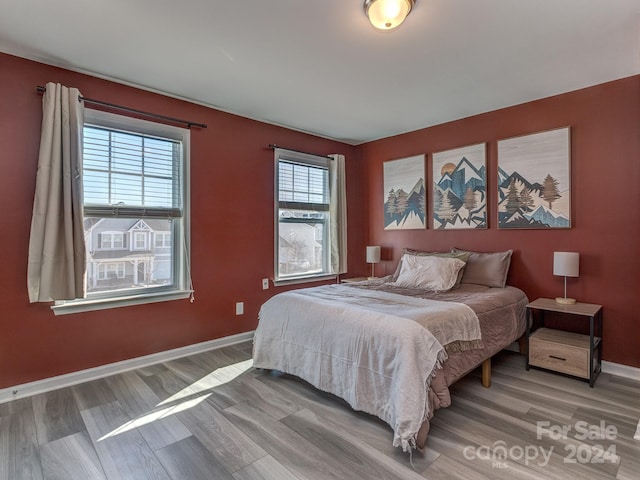 bedroom with hardwood / wood-style flooring