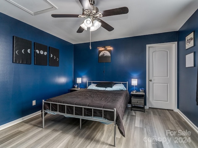 bedroom featuring hardwood / wood-style flooring and ceiling fan