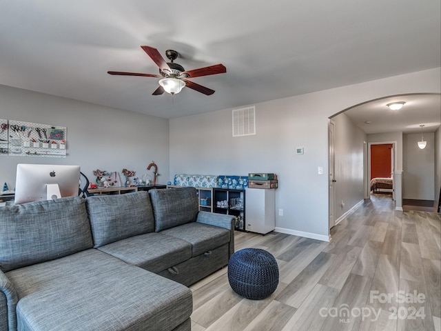 living room featuring ceiling fan and hardwood / wood-style flooring