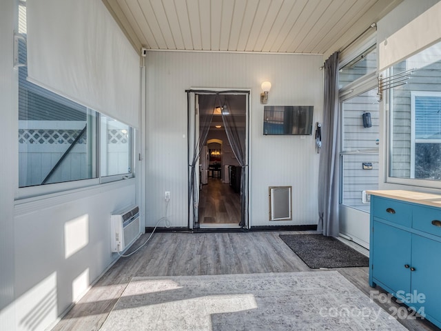 view of exterior entry with a wall mounted air conditioner