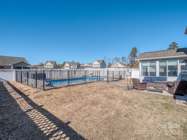 view of yard with an outdoor living space, a fenced in pool, and a patio