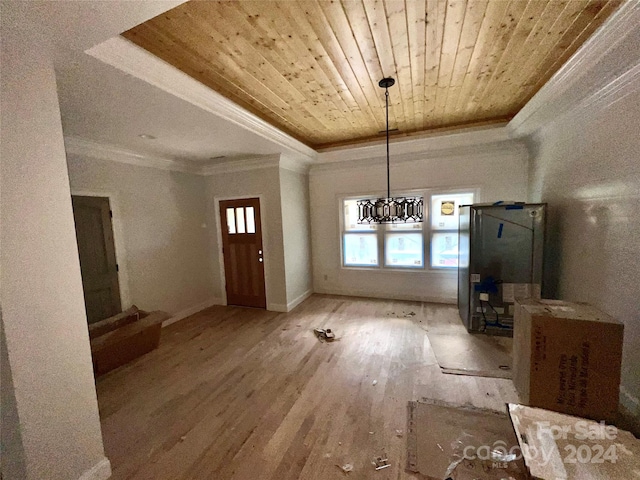 unfurnished dining area featuring wooden ceiling, crown molding, hardwood / wood-style floors, a chandelier, and a tray ceiling