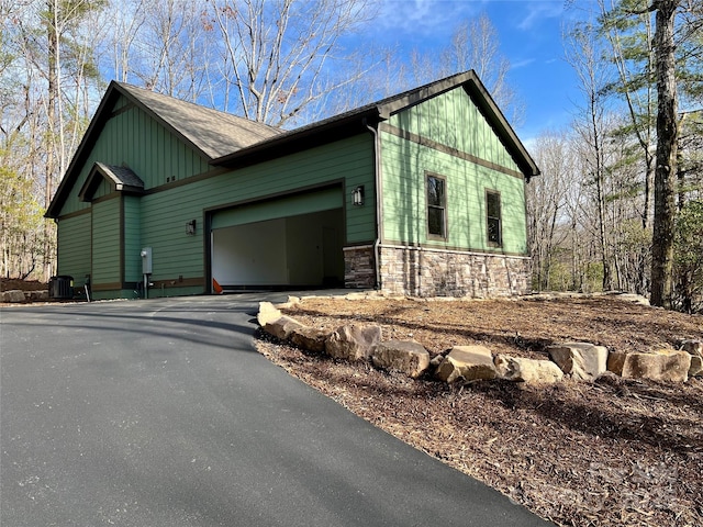 view of home's exterior featuring cooling unit and a garage