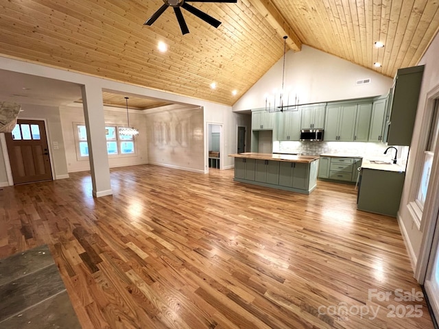 kitchen featuring high vaulted ceiling, wood-type flooring, hanging light fixtures, green cabinets, and wooden ceiling