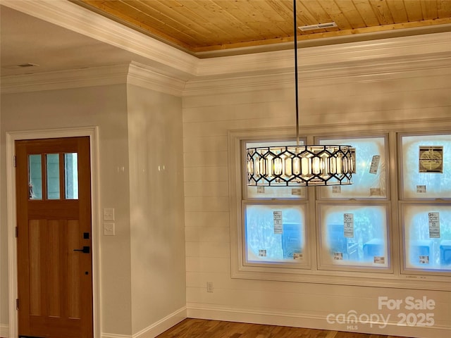 entrance foyer with crown molding, hardwood / wood-style flooring, and wooden ceiling