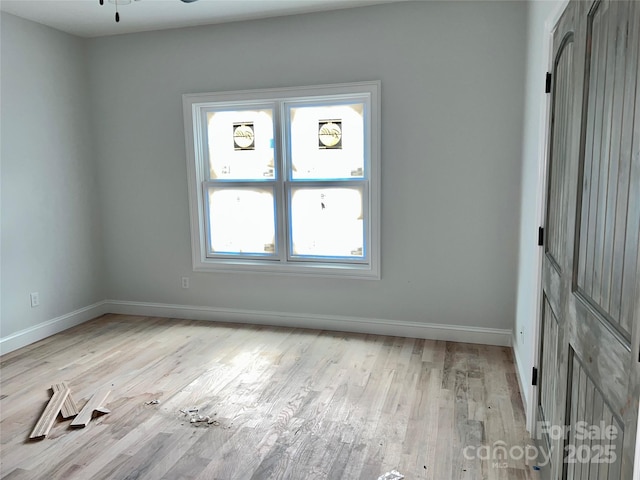 empty room featuring ceiling fan and light wood-type flooring