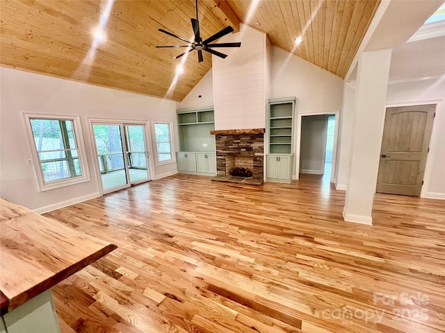 unfurnished living room with high vaulted ceiling, wooden ceiling, light wood-style flooring, baseboards, and ceiling fan