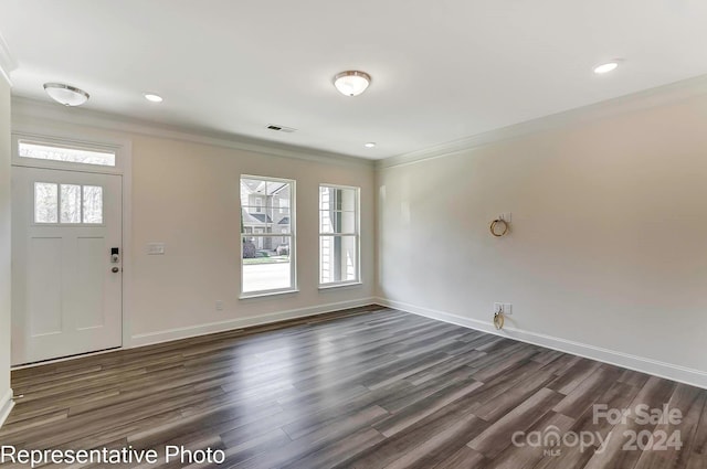 entrance foyer with dark hardwood / wood-style flooring, a wealth of natural light, and crown molding