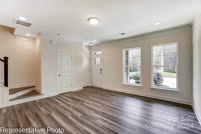 interior space with dark hardwood / wood-style floors and crown molding