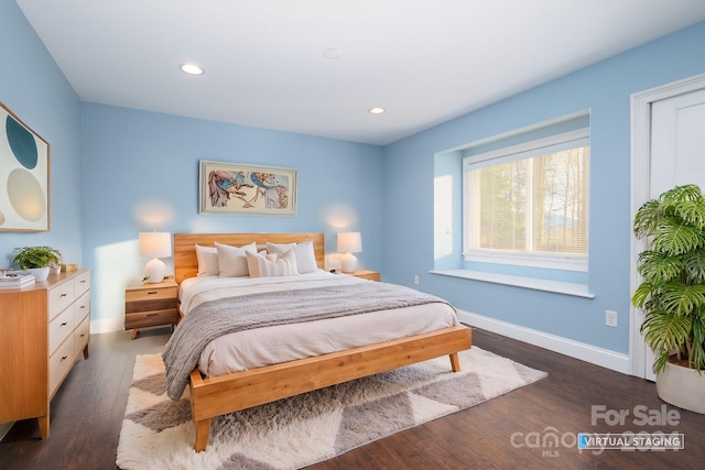 bedroom with dark hardwood / wood-style floors