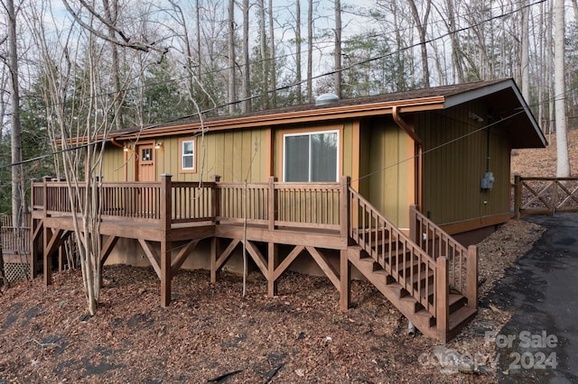 back of property with a wooden deck