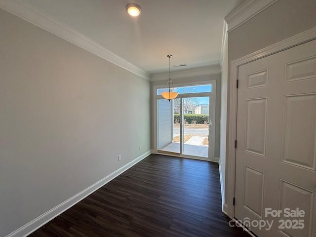 empty room featuring baseboards, dark wood-type flooring, visible vents, and crown molding