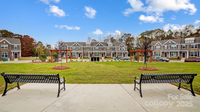 view of home's community featuring a yard, a residential view, and a pergola