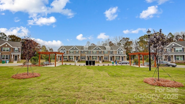 surrounding community with a lawn and a pergola