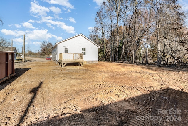 back of house with a deck