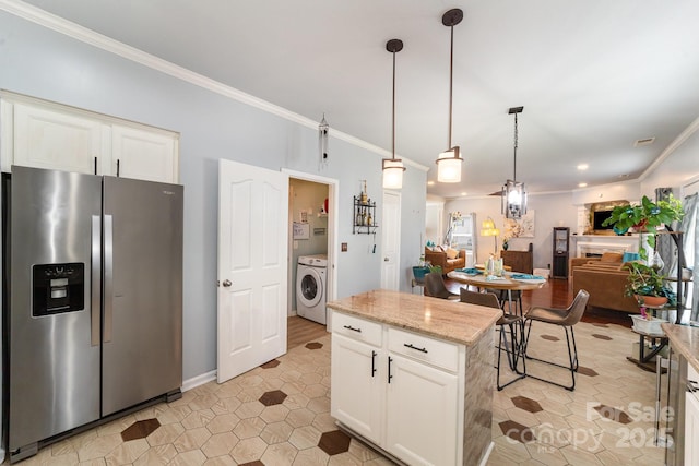 kitchen with open floor plan, washer / clothes dryer, pendant lighting, stainless steel fridge with ice dispenser, and light stone countertops