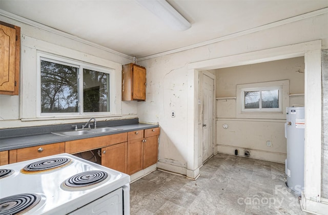 kitchen featuring sink, white range oven, ornamental molding, and water heater