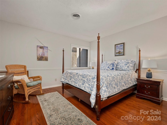 bedroom featuring dark hardwood / wood-style flooring