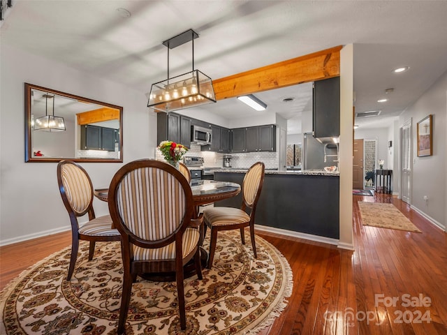 dining space with dark hardwood / wood-style floors