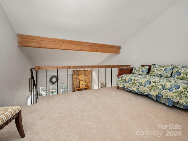 bedroom featuring carpet and lofted ceiling with beams