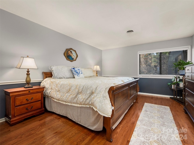 bedroom with dark hardwood / wood-style floors