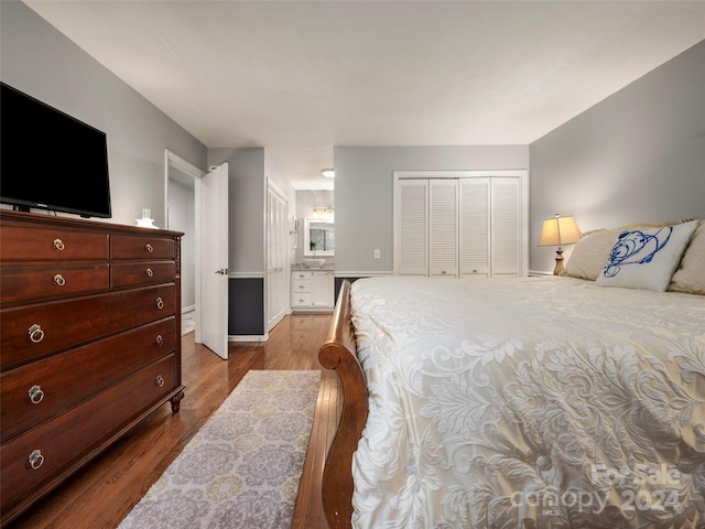 bedroom featuring hardwood / wood-style floors and a closet