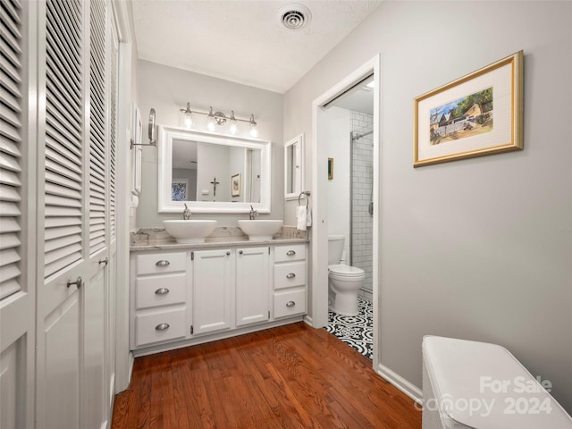 bathroom with vanity, hardwood / wood-style flooring, and toilet