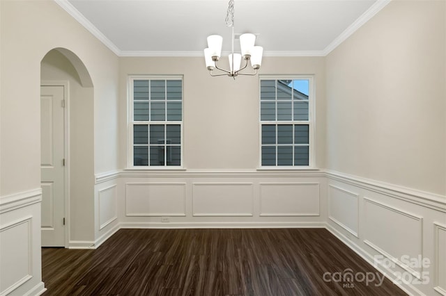 unfurnished dining area with ornamental molding, dark hardwood / wood-style flooring, and a notable chandelier