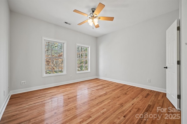 spare room featuring light hardwood / wood-style floors and ceiling fan