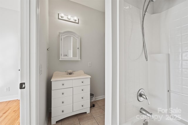 bathroom with vanity, tile patterned floors, and  shower combination