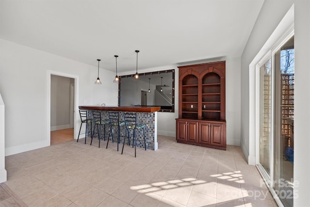 bar featuring pendant lighting and light tile patterned floors