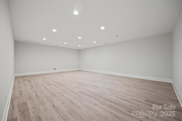 empty room with light hardwood / wood-style flooring