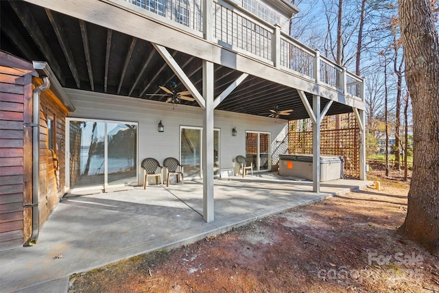 view of patio / terrace featuring ceiling fan and a hot tub