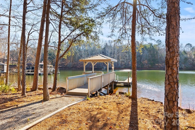 view of dock with a gazebo and a water view