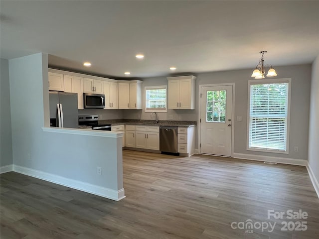 718 Park Ave, Salisbury, NC 28144 - kitchen featuring stainless steel appliances, white cabinetry, wood finished floors, baseboards, and recessed lighting
