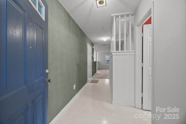 foyer with a textured ceiling