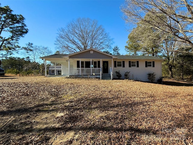 back of property featuring covered porch