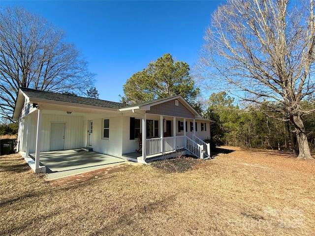 back of property featuring covered porch